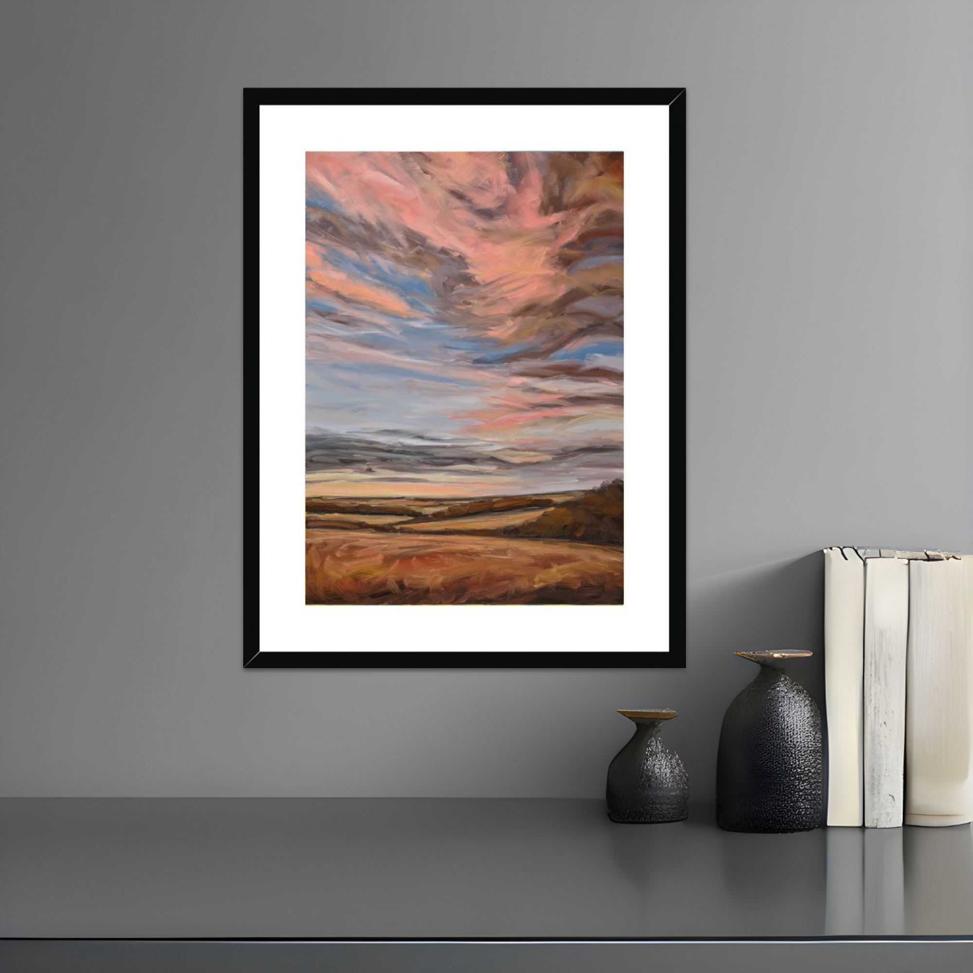 Framed abstract artwork on a gray wall with decorative items below.