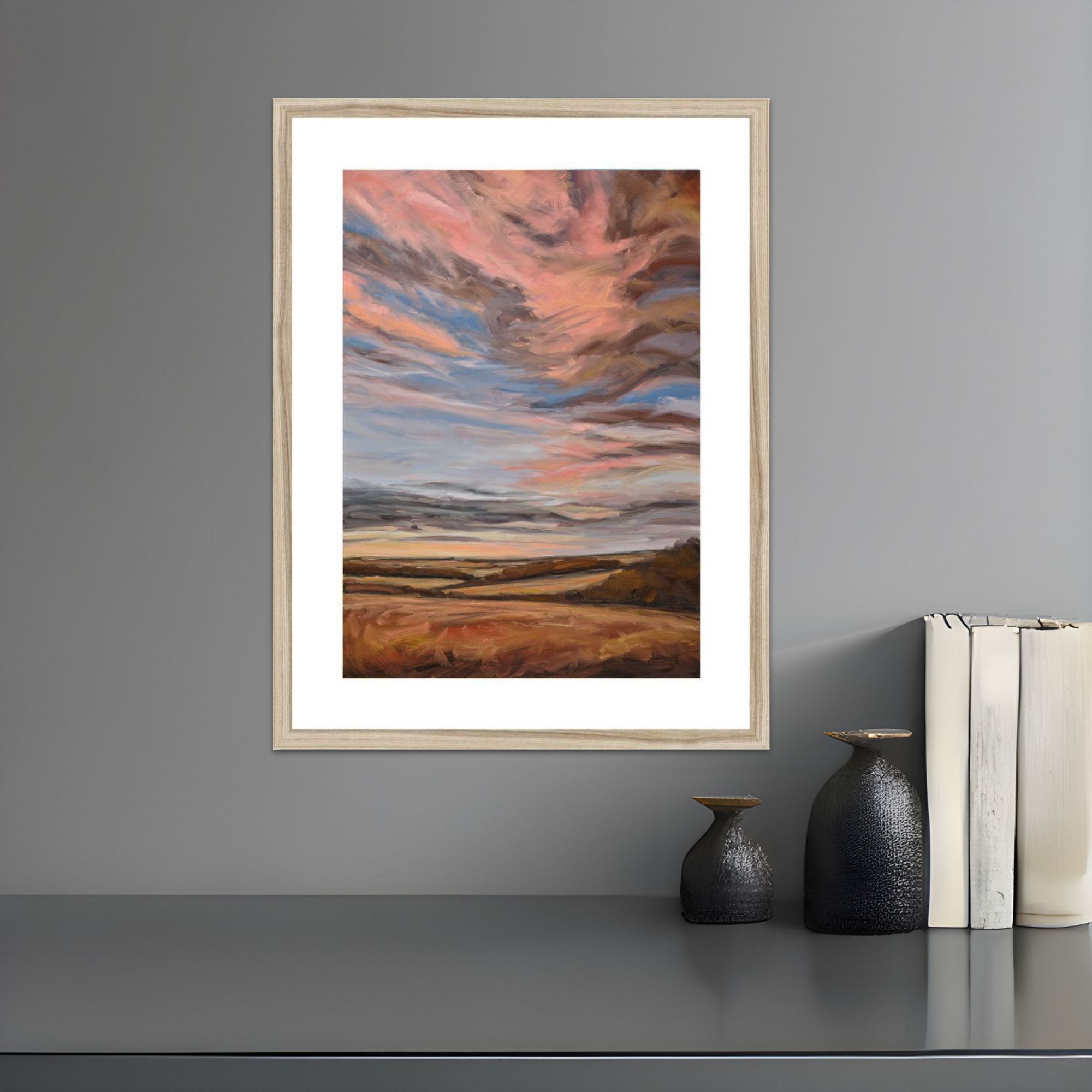Framed abstract artwork on a gray wall with decorative items below.