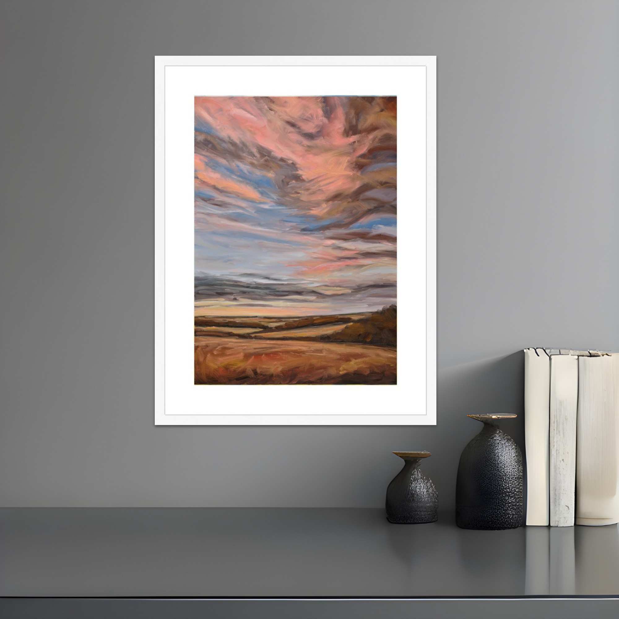 Framed abstract artwork on a gray wall with decorative items below.