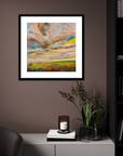 Framed abstract painting on a wall with a side table and decorative items below.