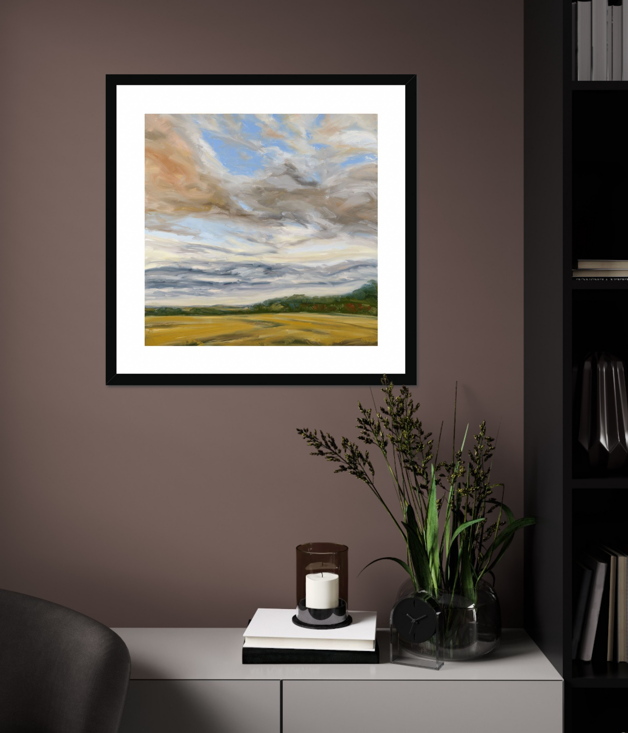 Framed landscape painting on a wall above a cabinet with decorative items.