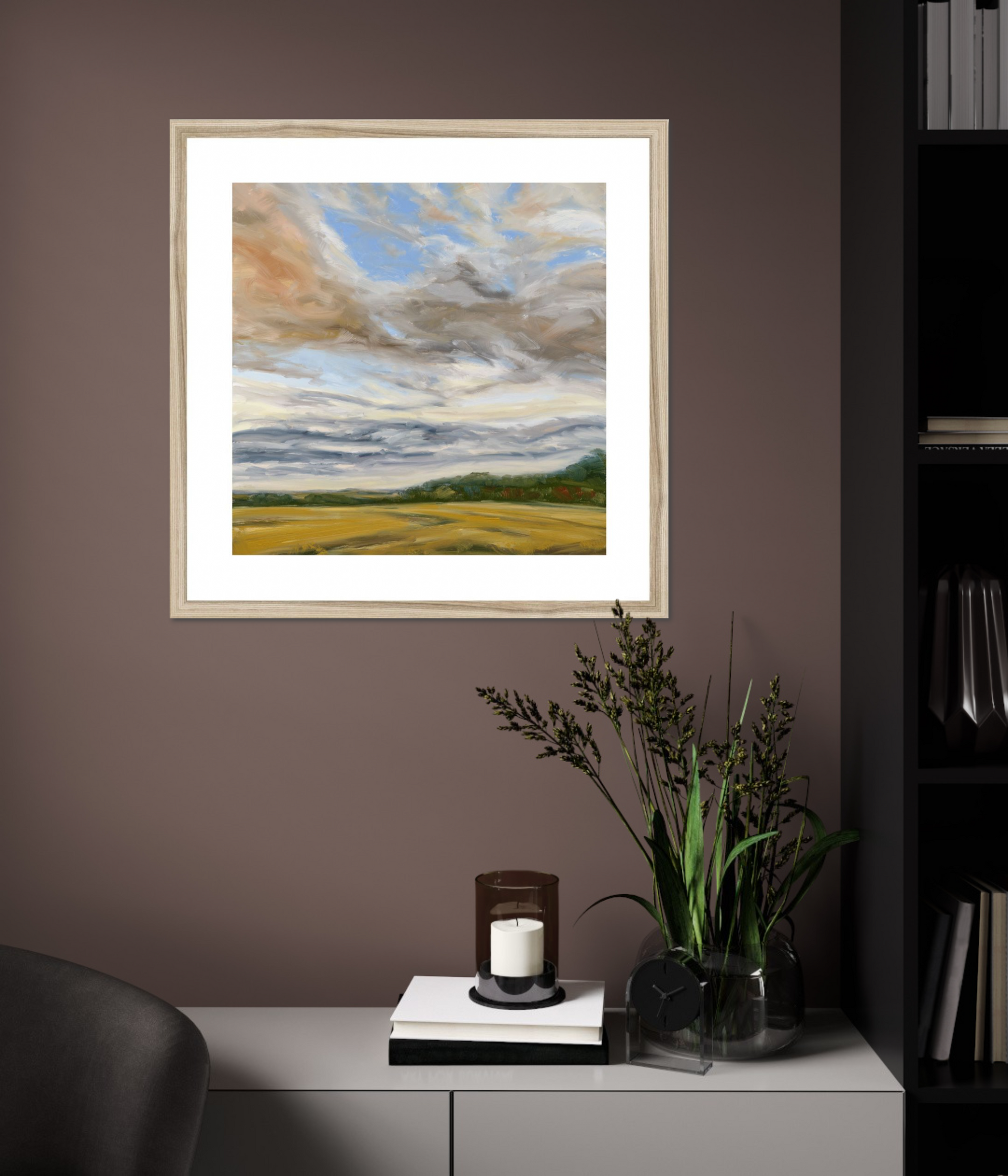 Framed landscape painting on a wall above a cabinet with decorative items.