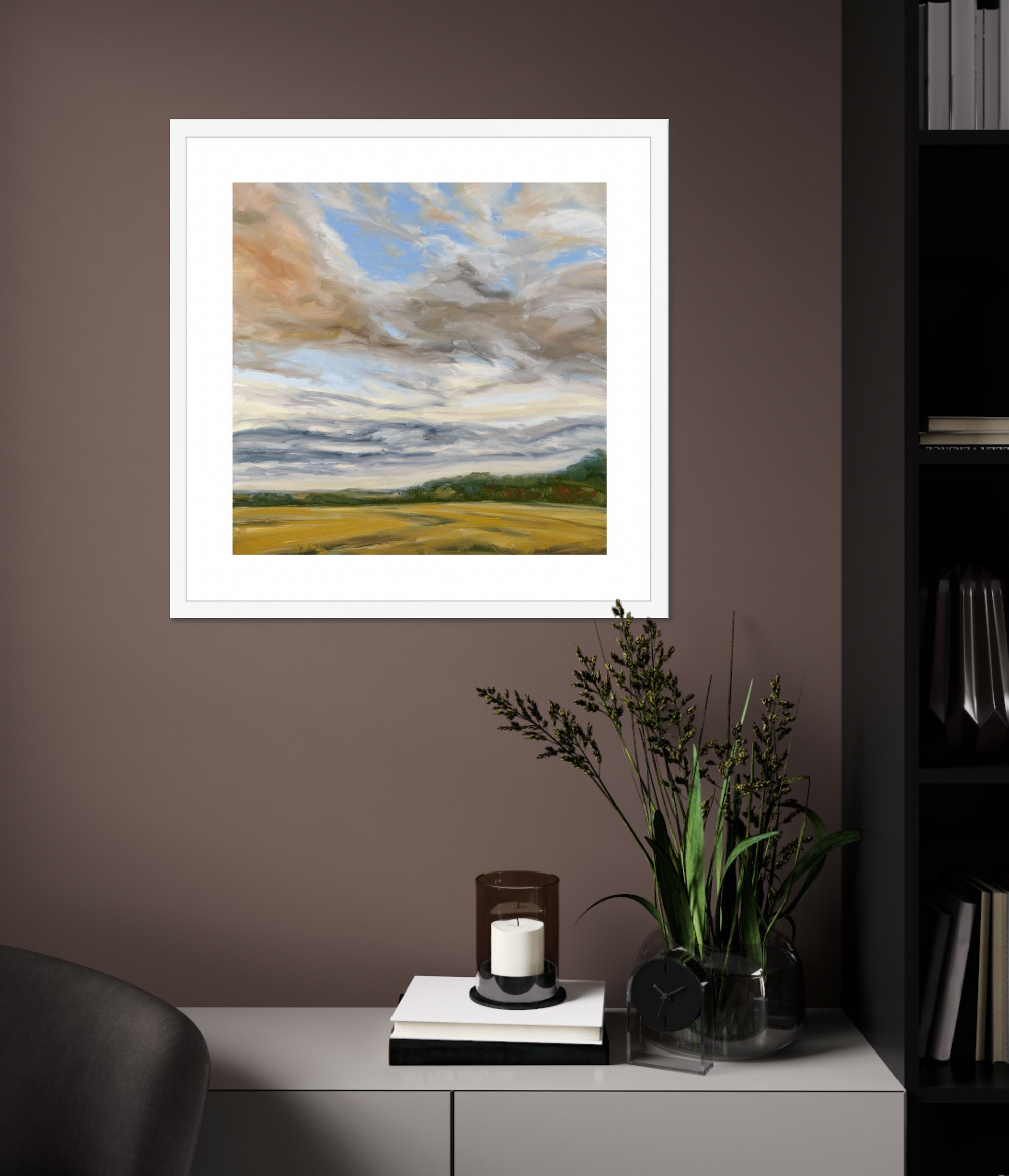 Framed landscape painting on a wall above a cabinet with decorative items.