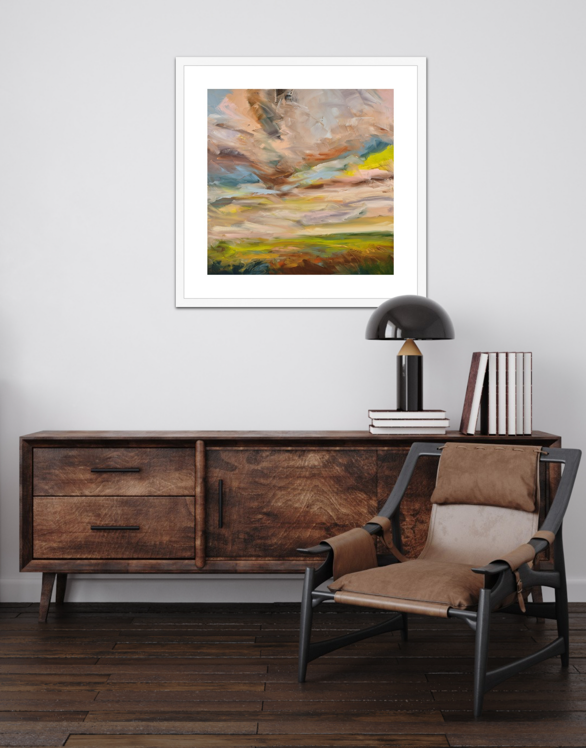 Wooden sideboard with a chair, books, and a lamp in a room with a colorful abstract painting on the wall.