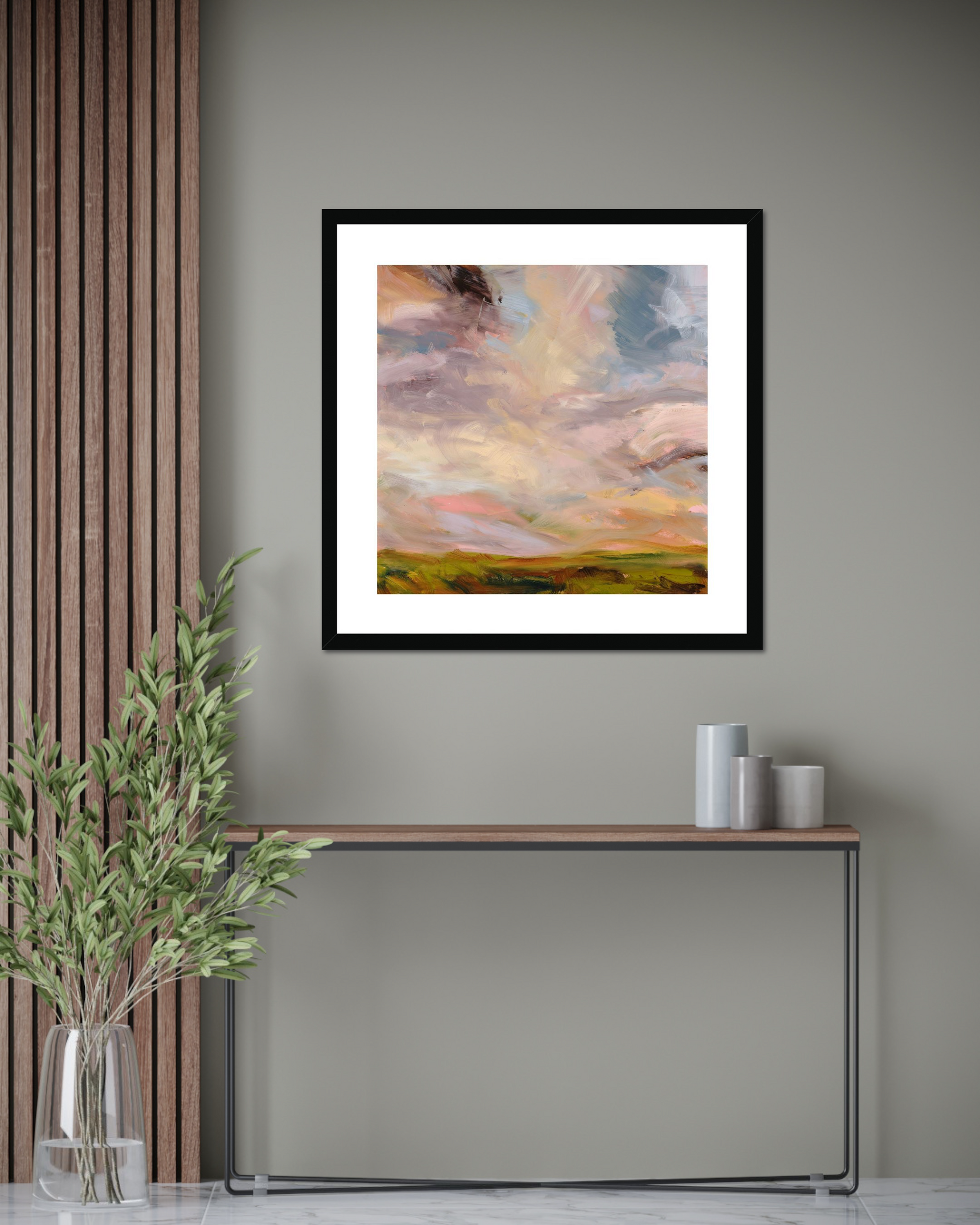 Framed abstract painting on a wall with a console table and decorative items below.
