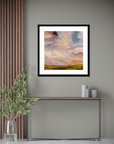 Framed abstract painting on a wall with a console table and decorative items below.