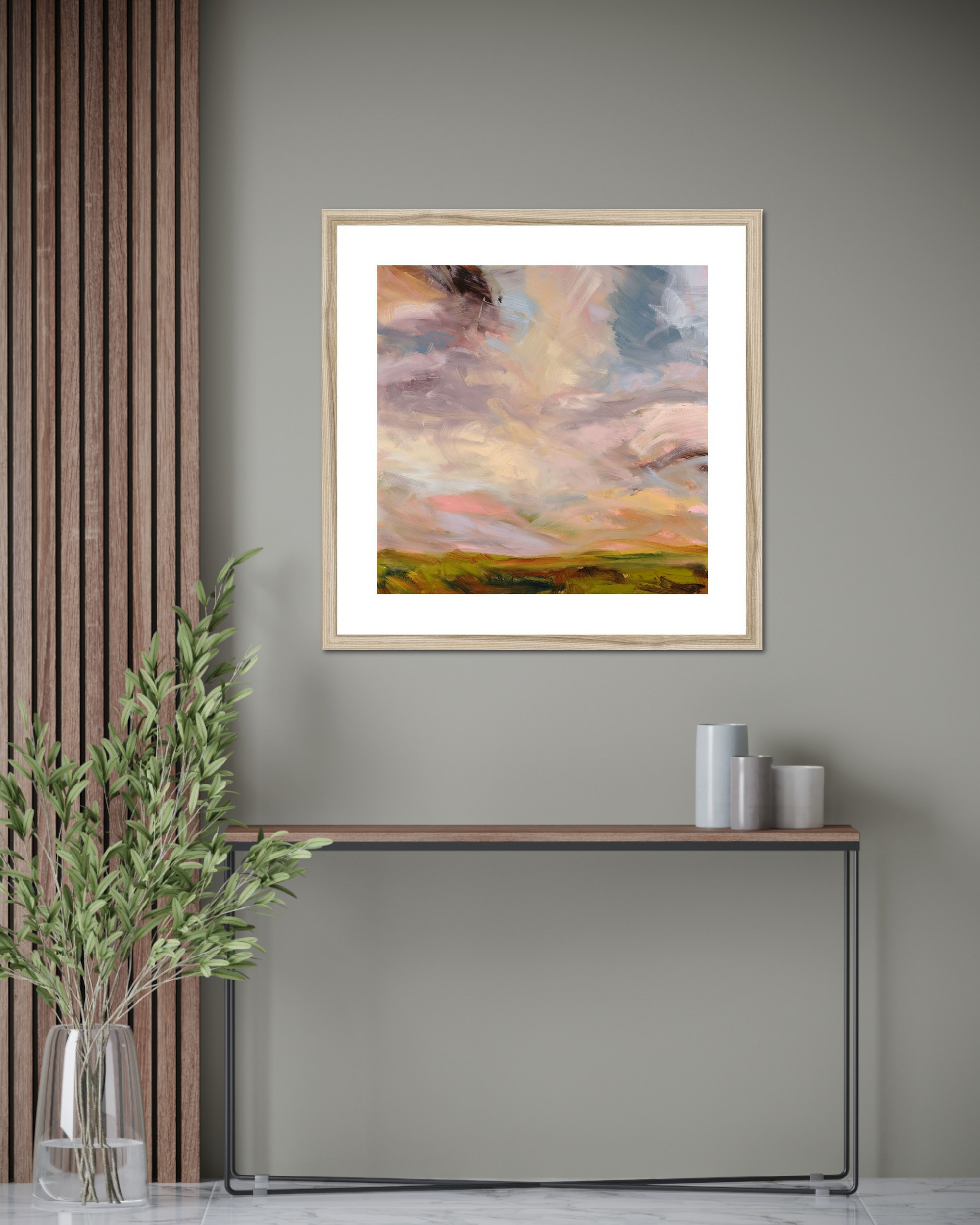 Framed abstract painting on a wall with a console table and decorative items below.
