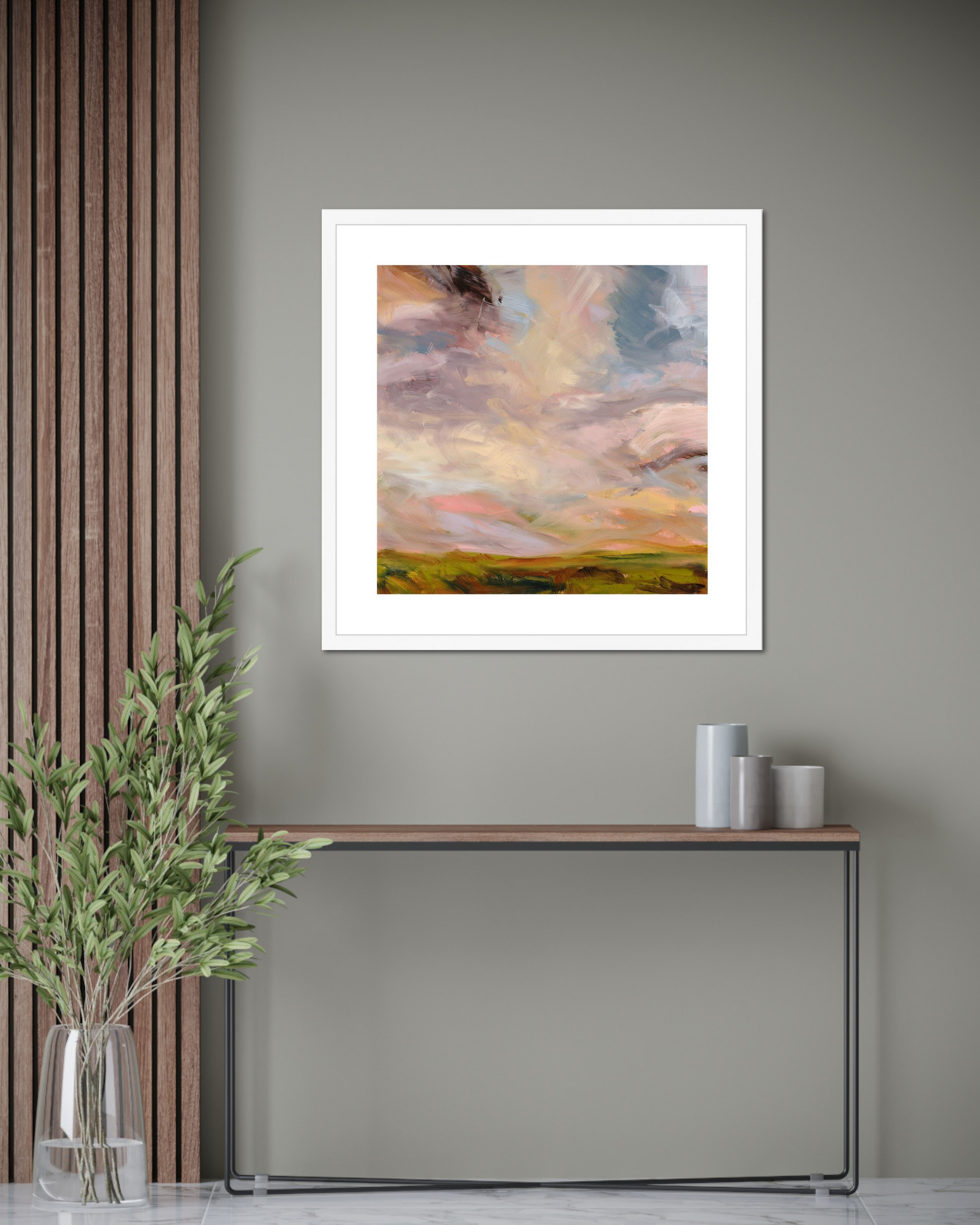 Framed abstract painting on a wall with a console table and decorative items below.