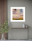 Framed abstract painting on a wall with a console table and decorative items below.