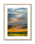 Framed abstract painting of a landscape with colorful skies and green fields.