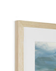 Close-up of a wooden picture frame with a blurred artwork inside on a white background