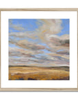 Framed painting of a landscape with a blue sky and yellow field.