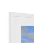 Close-up of a white frame with a blurred abstract painting inside