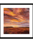 Framed abstract painting of a sunset with warm colors.