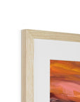 Close-up of a wooden picture frame with a colorful painting inside on a white background