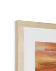 Close-up of a wooden picture frame with a colorful painting inside on a white background