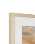 Close-up of a wooden picture frame with a blurred artwork inside on a white background