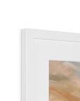 Close-up of a white picture frame with a blurred artwork inside on a white background
