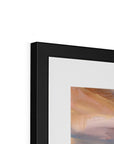 Framed abstract painting with a black frame on a white wall