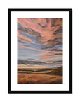 Framed abstract landscape painting with warm colors on a white background