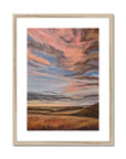 Framed abstract landscape painting with warm colors on a white background