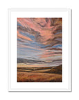Framed abstract landscape painting with warm colors on a white background