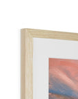 Close-up of a wooden picture frame with a painting inside on a white background