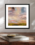 Framed abstract painting on a wooden surface with a book underneath