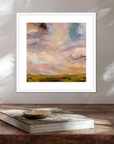 Framed abstract painting on a wooden surface with a book underneath