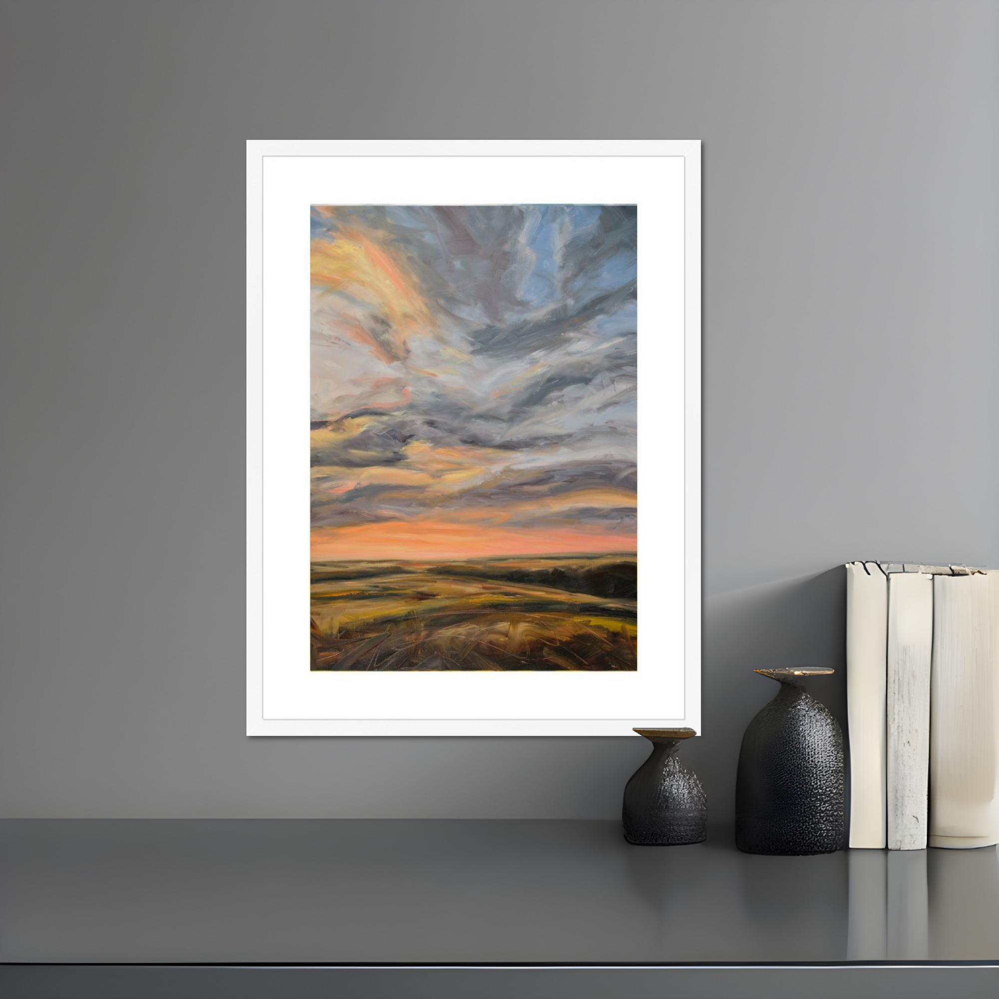 Framed abstract landscape painting on a gray wall with decorative vases and books below.