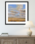 Framed abstract painting above a wooden console table with a lamp and books.