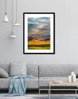 Framed abstract painting on a wall above a sofa in a living room