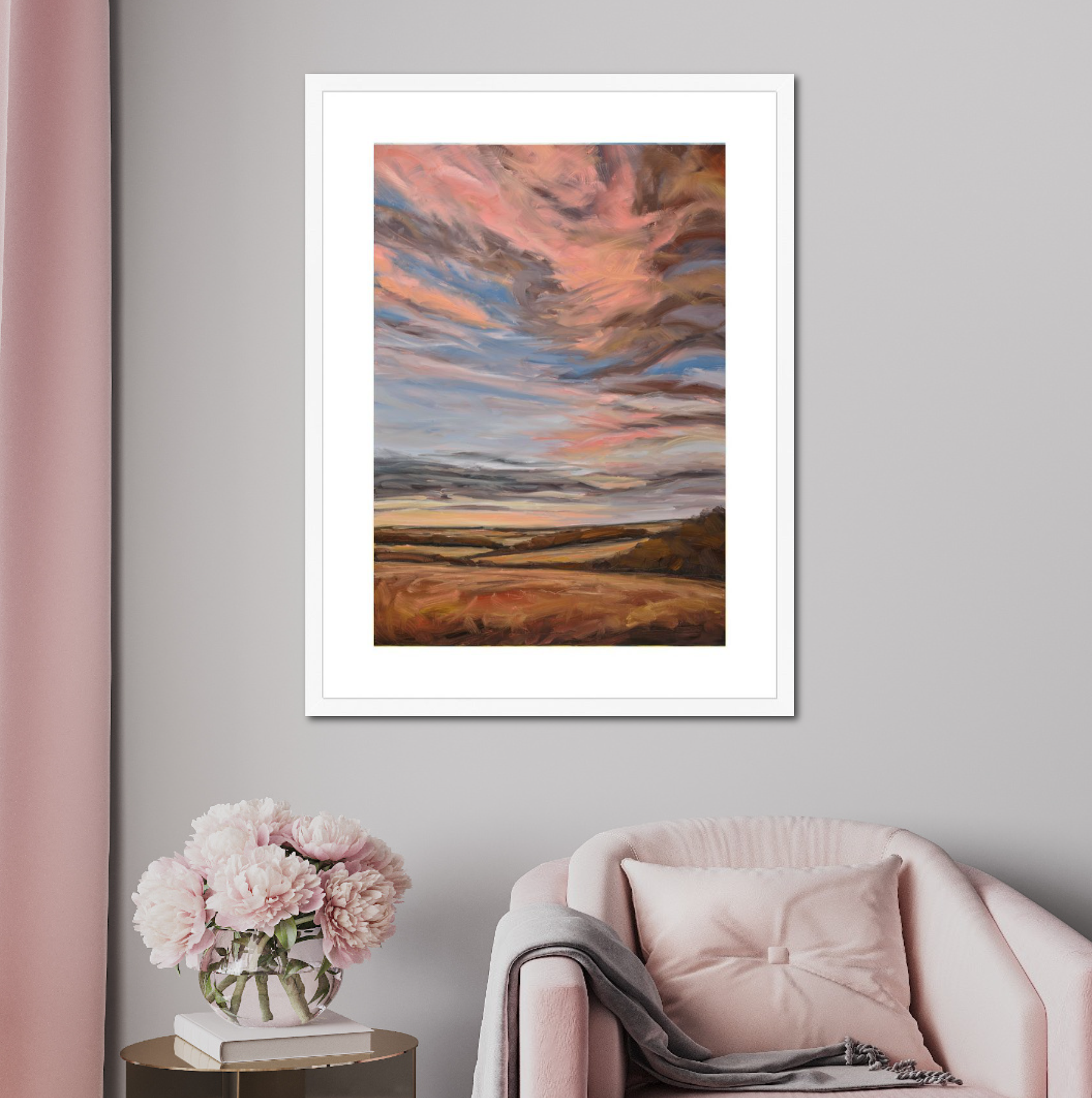 Framed abstract artwork on a gray wall with a pink chair and floral arrangement.