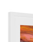 Close-up of a white frame with an abstract painting inside, featuring orange and pink colors.
