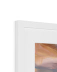 Close-up of a white picture frame with a painting inside, showing brush strokes in brown and beige.