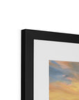 Close-up of a black framed artwork with abstract colors on a white background